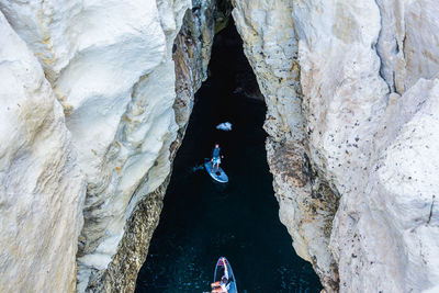 High angle view of people paddleboarding in sea