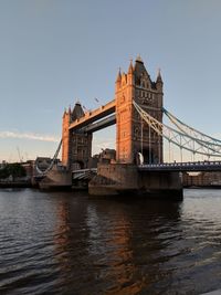 Bridge over river with city in background