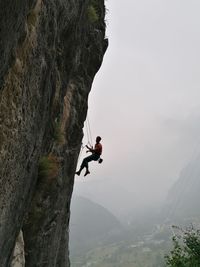 Man on rock against mountain range