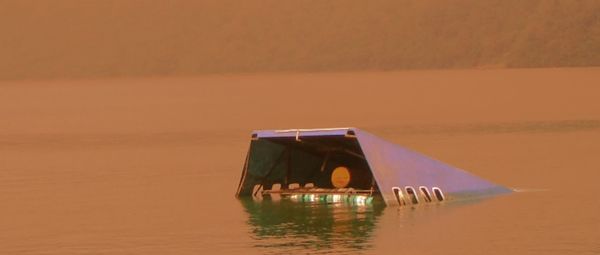 View of boat in sea at sunset