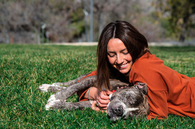 Happy pet owner with dog in park