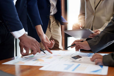 Midsection of business people working in office