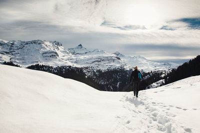 Tourists on snow covered mountain