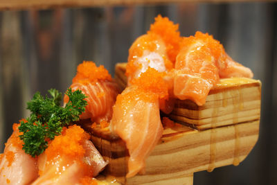 Close-up of salmon sushi served on wood