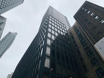 Low angle view of modern buildings against sky in city