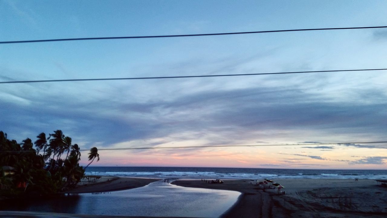 sky, water, tranquil scene, scenics, tranquility, beauty in nature, cloud - sky, sea, nature, transportation, tree, cloud, sunset, horizon over water, power line, road, no people, idyllic, outdoors, cloudy