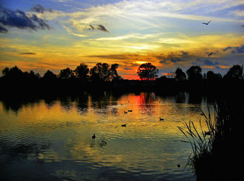 Scenic view of lake against sky during sunset