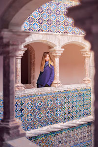 Woman standing in balcony and looking away