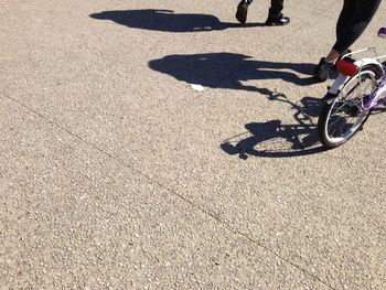 Low section of man riding bicycle on street