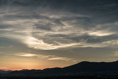 Scenic view of silhouette mountains against sky during sunset