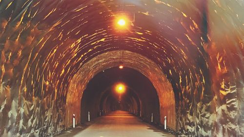 Illuminated tunnel at night