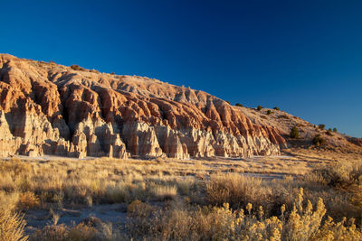 Rock formations desert canyon against clear blue sky