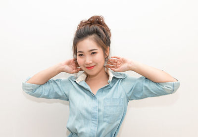 Portrait of a smiling young woman over white background