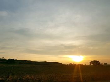 Scenic view of field against sky during sunset