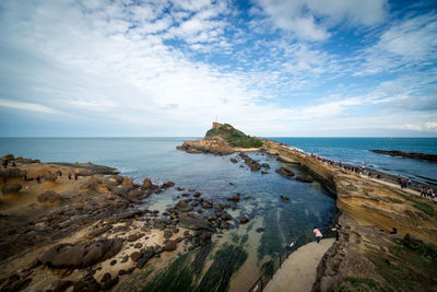 Scenic view of sea against cloudy sky