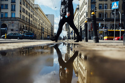 Reflection of buildings in puddle on street