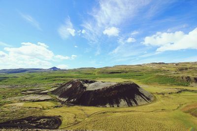 Scenic view of agricultural field against blue sky