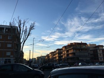 Cars on city against sky