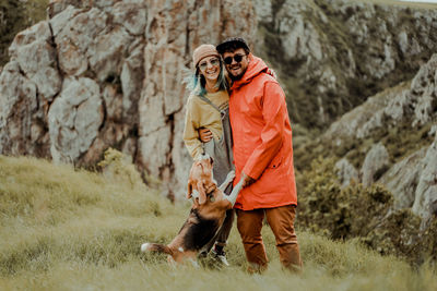 Rear view of a couple in love with dog outdoors