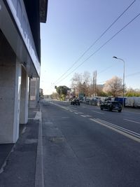 Road by city against sky