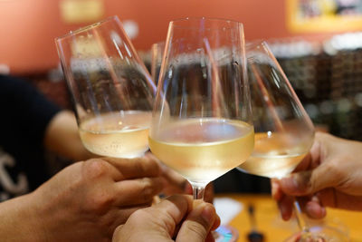 Close-up of hands raising toast