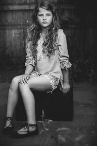 Portrait of young woman sitting on chair