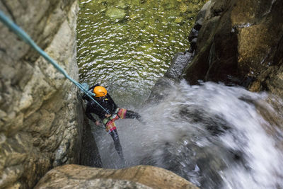 Man surfing on rock