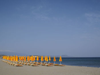 Scenic view of beach against clear blue sky