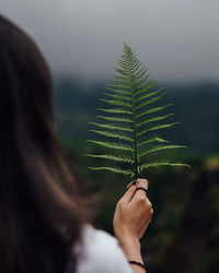 Close-up of woman holding plant