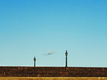 Low angle view of built structure against clear blue sky