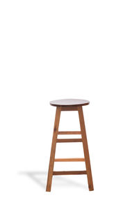 Empty chair on table against white background