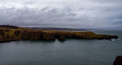 Rock formation in sea against sky