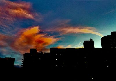 Low angle view of silhouette buildings against sky during sunset