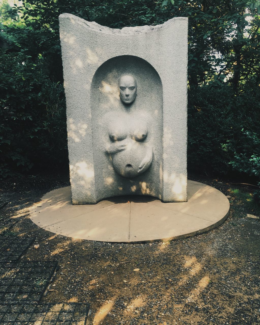 CLOSE-UP OF SCULPTURE AGAINST TREE