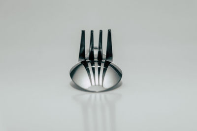 Close-up of empty glasses on table against white background
