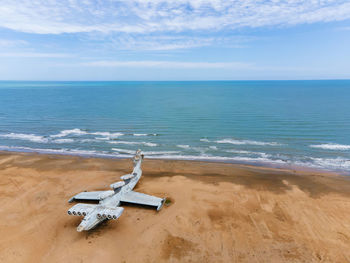 Military abandoned lun plane stands on a beach in dagestan