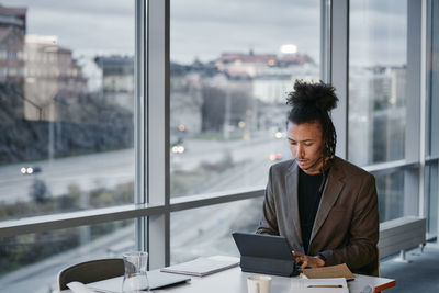 Young businessman using tablet in office