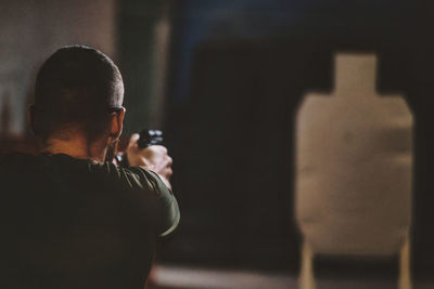 Side view of man standing in room