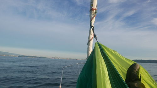 Close-up of sailboat against sky over sea