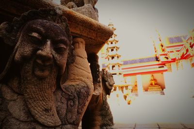 Low angle view of statue against temple building