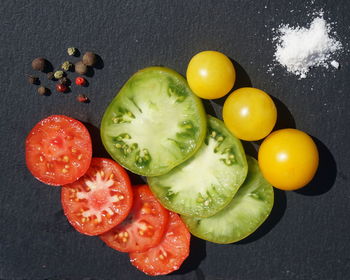 High angle view of fruits on table against black background