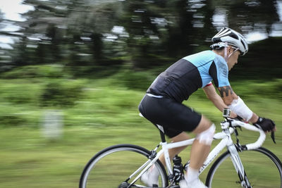 Blurred motion of man cycling bicycle