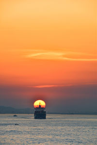 Scenic view of sea against orange sky