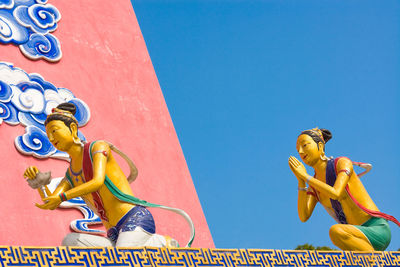 Low angle view of statue against clear blue sky