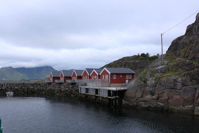 View of river by mountain against sky