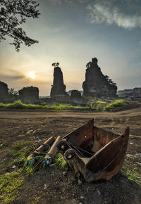 Old ruin on field against sky during sunset