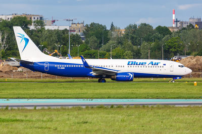 Airplane on runway against sky