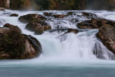 Long exposure photograph of the rhein falls with the laufen castle on the background.