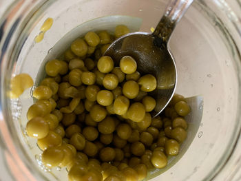 High angle view of green peas in container