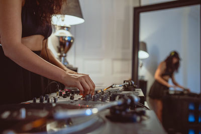 Fashionable young woman playing music at home